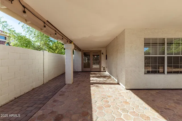 a view of a house with backyard sitting area and swimming pool