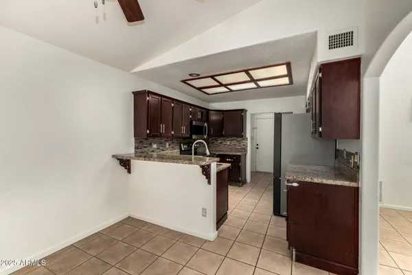 a kitchen with refrigerator and window