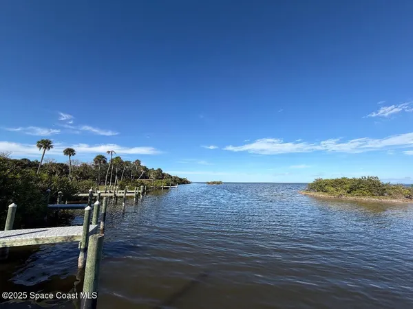 a view of a terrace with lawn chairs