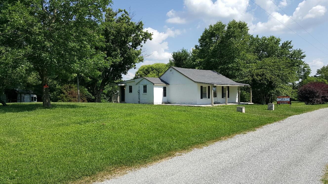 719 Highland Road Red Boiling Springs, TN 37150 - Photo 2 of 12 a front view of a house with a yard and trees