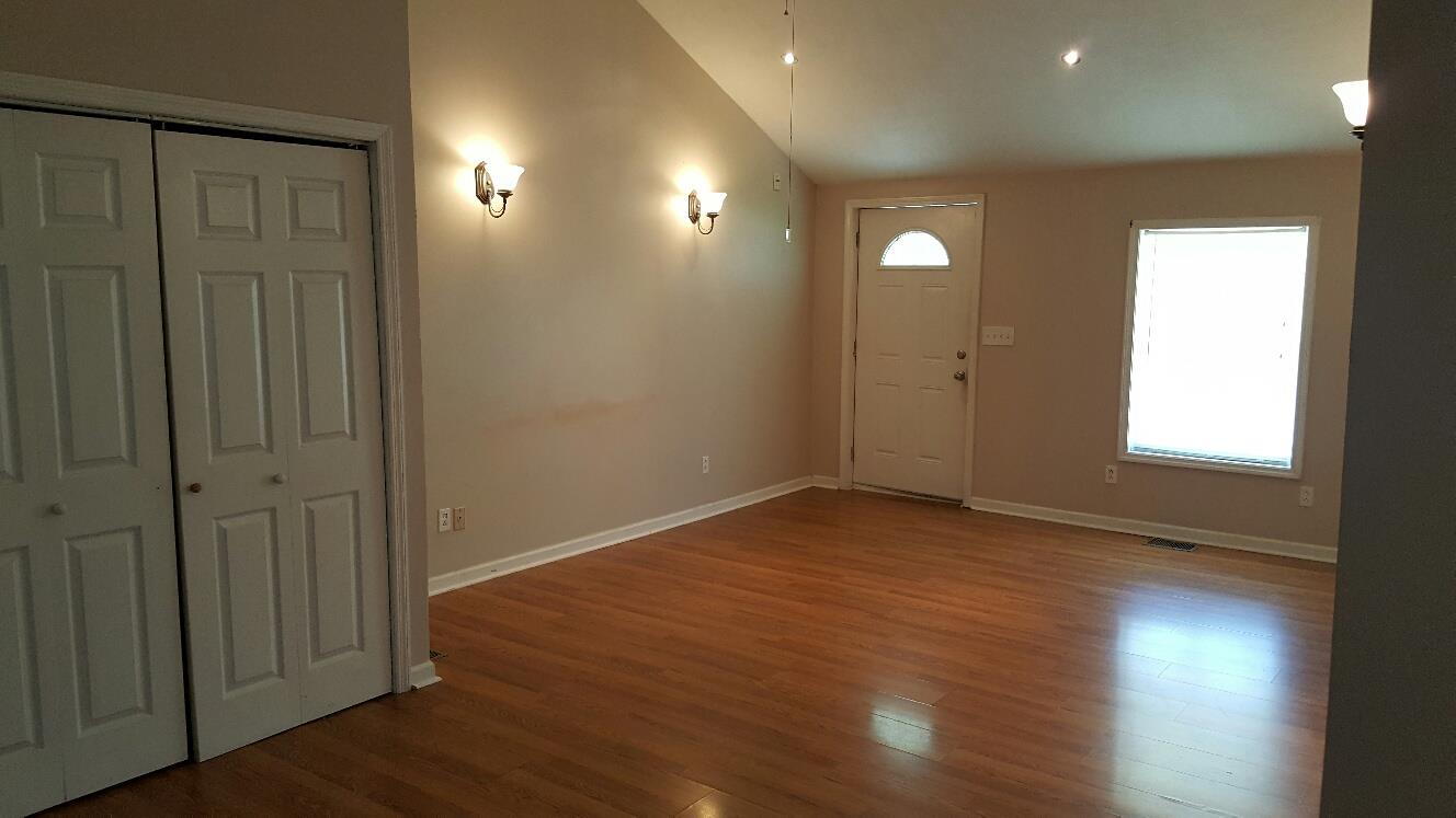 719 Highland Road Red Boiling Springs, TN 37150 - Photo 6 of 12 an empty room with wooden floor and windows