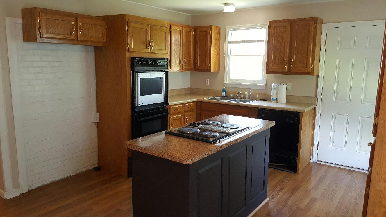 719 Highland Road Red Boiling Springs, TN 37150 - Photo 8 of 12 a kitchen with a stove and a refrigerator