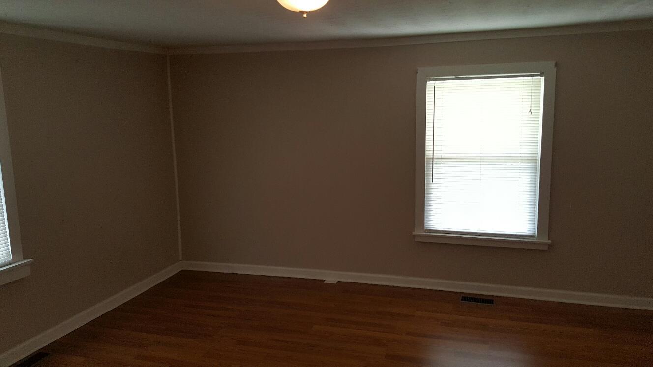 719 Highland Road Red Boiling Springs, TN 37150 - Photo 10 of 12 an empty room with wooden floor and a window