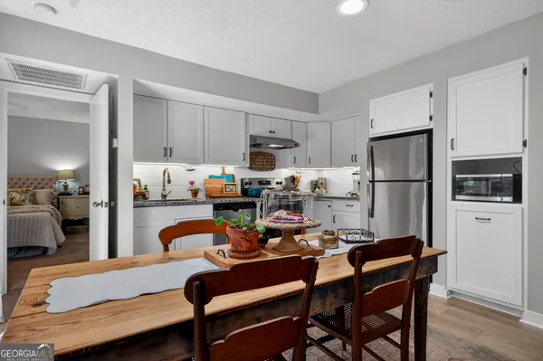 a kitchen with a refrigerator a stove a sink and a refrigerator