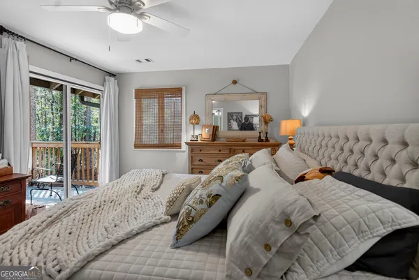 a bedroom with furniture and large windows