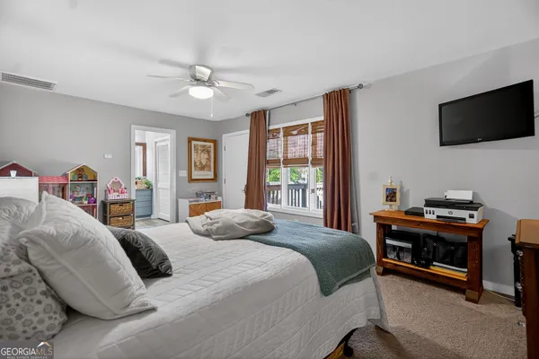a bedroom with a bed and a flat screen tv