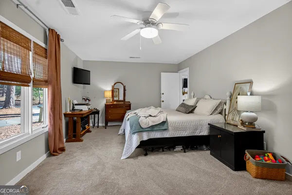 a bedroom with bed and a chandelier