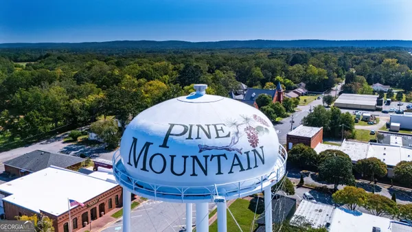 an aerial view of a house with yard swimming pool and outdoor seating