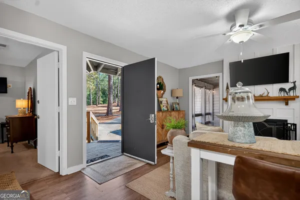 a view of living room with furniture and flat screen tv