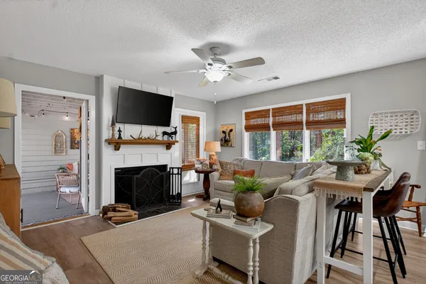 a living room with furniture a flat screen tv and a fireplace