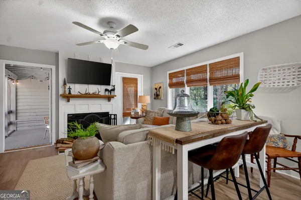 a living room with furniture a fireplace and a flat screen tv