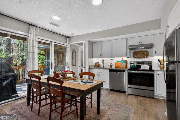 a kitchen with sink cabinets and dining table
