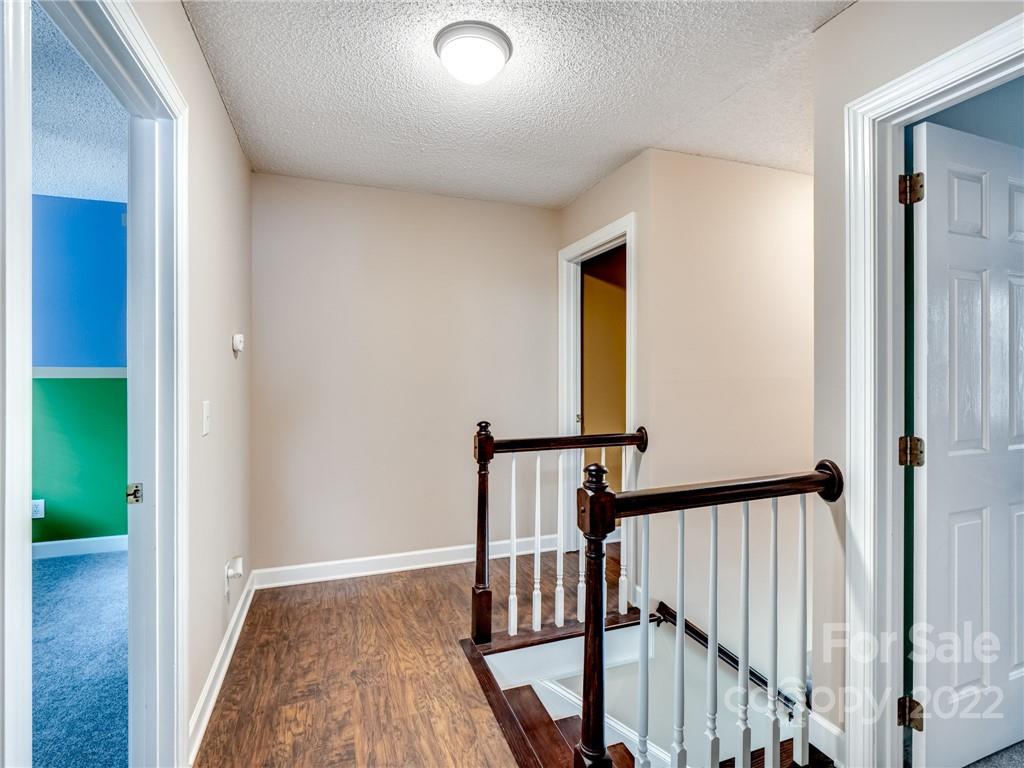1663 Heather Glen Road Kannapolis, NC 28081 - Photo 18 of 30 a view of hallway with wooden floor and stairs