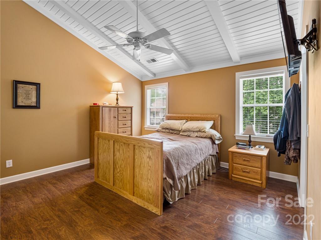1663 Heather Glen Road Kannapolis, NC 28081 - Photo 19 of 30 a spacious bedroom with a bed and a chandelier