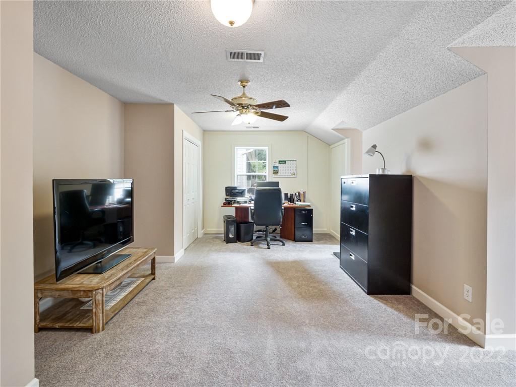 1663 Heather Glen Road Kannapolis, NC 28081 - Photo 26 of 30 a living room with furniture and a flat screen tv