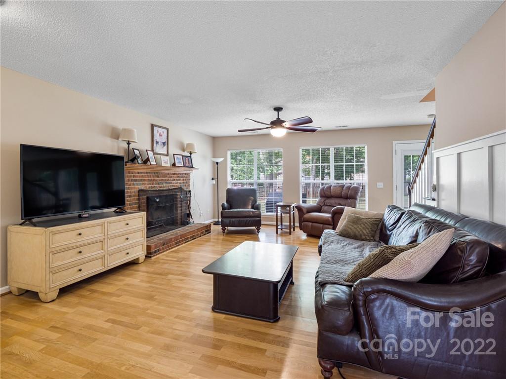 1663 Heather Glen Road Kannapolis, NC 28081 - Photo 6 of 30 a living room with furniture flat screen tv and a fireplace
