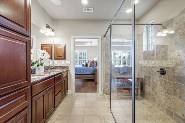 a kitchen with stainless steel appliances kitchen island granite countertop a refrigerator and a sink