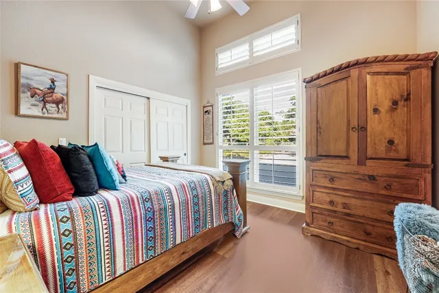 a bedroom with a bed next to a window