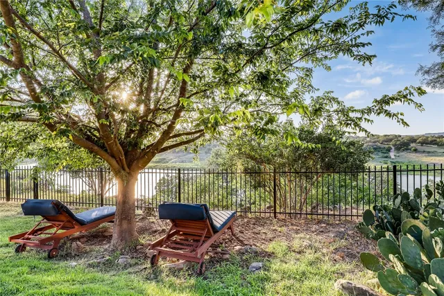 a view of a swimming pool and lounge chairs