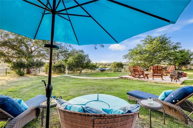 an aerial view of residential houses with outdoor space and lake view