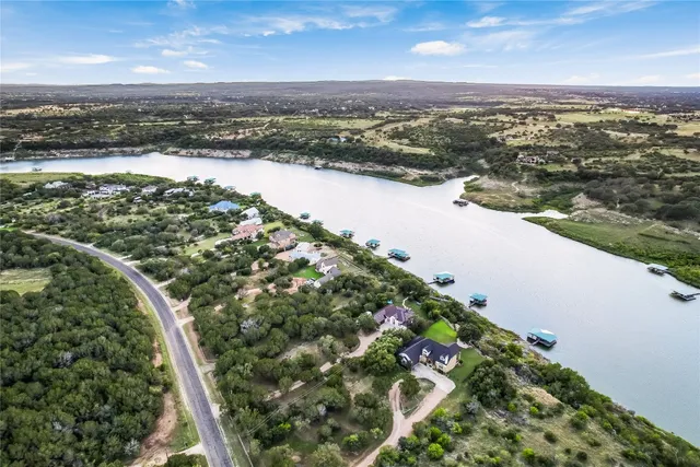 an aerial view of a house with garden space and lake view