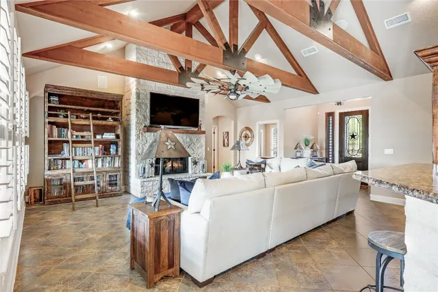 a living room with furniture a flat screen tv and a fireplace