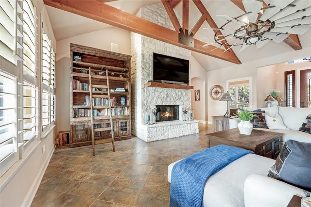 a living room with furniture a flat screen tv and a fireplace