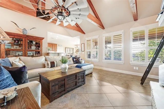 a living room with furniture and a floor to ceiling window