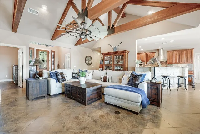 a living room with furniture and a chandelier