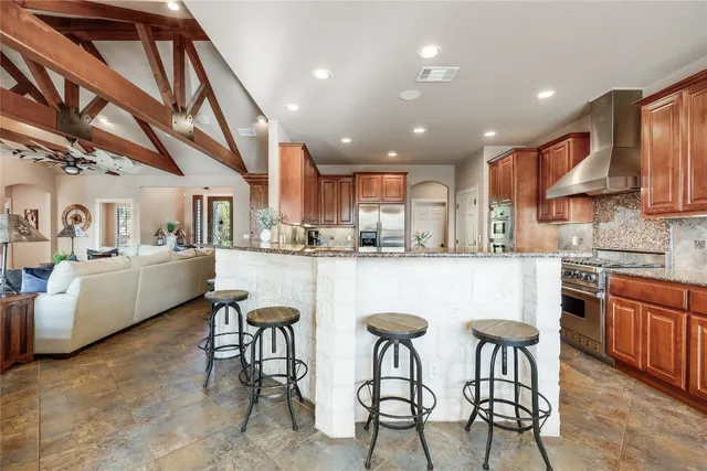 a kitchen with white cabinets and chairs