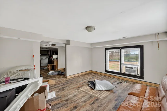 a bedroom with a bed and a large window