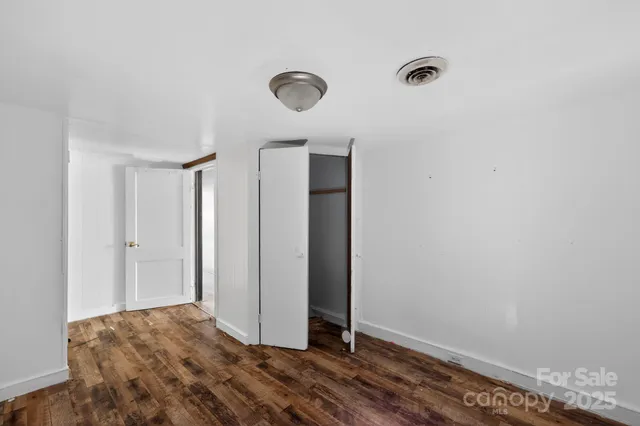 a bathroom with a granite countertop sink toilet and mirror