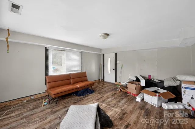 a bedroom with bed couch and window