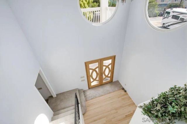 a view of a hallway with wooden floor and entryway