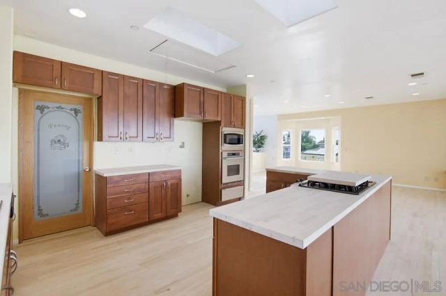 an empty room with windows and painted walls