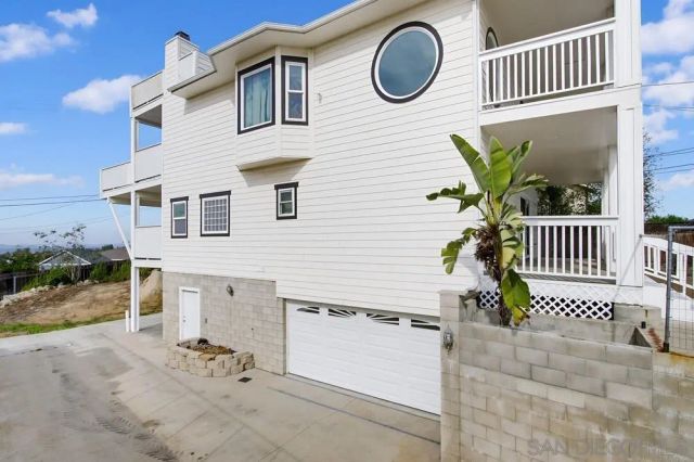 a view of a brick house with wooden fence