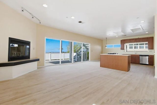 a large kitchen with a large window and a fireplace