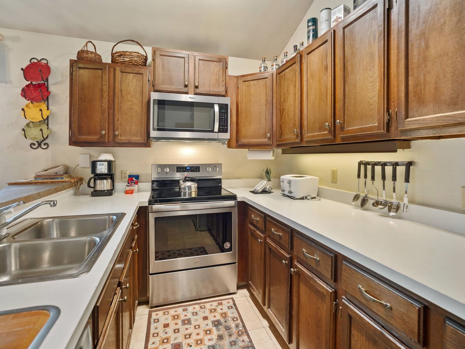 1937 Soda Ridge Road, Unit 1139 Keystone, CO 80435 - Photo 10 of 32 Kitchen featuring appliances with stainless steel finishes, light tile patterned flooring, sink, and vaulted ceiling