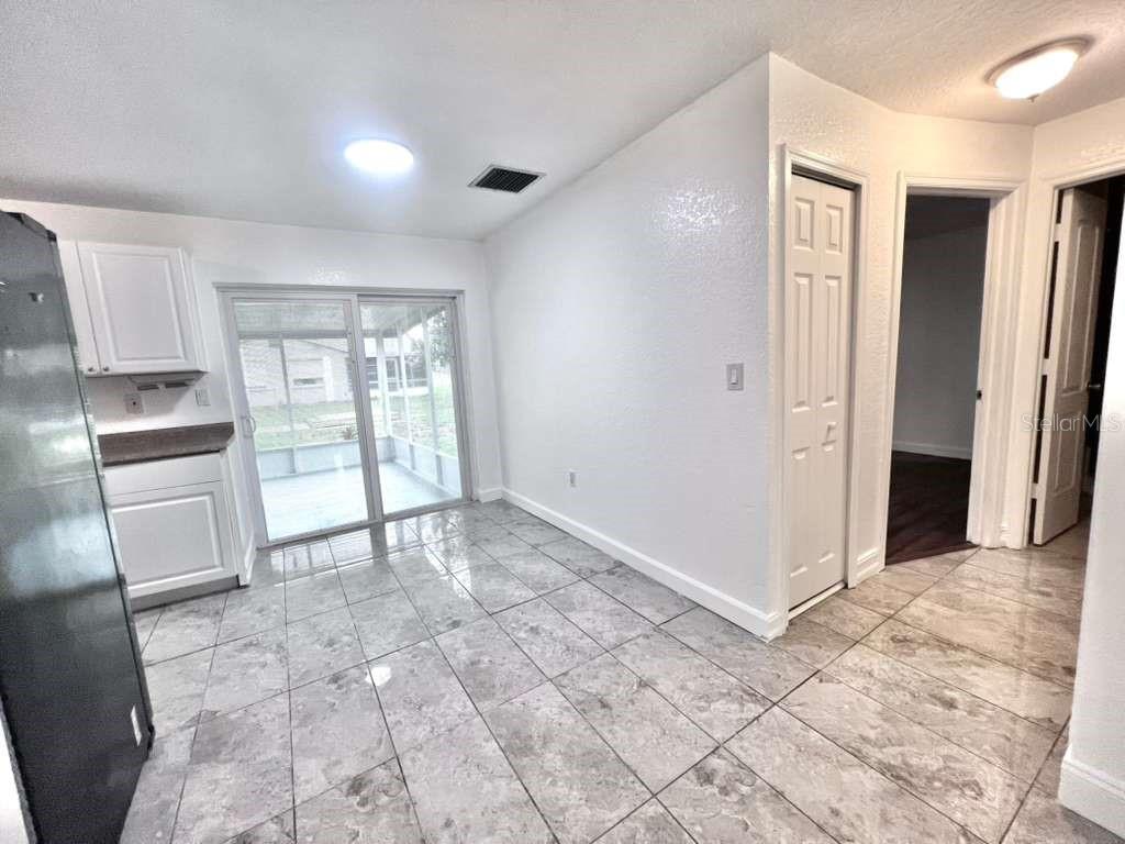 3409 Vorden Street New Port Richey, FL 34655 - Photo 16 of 41 a view of an empty room with kitchen and a window
