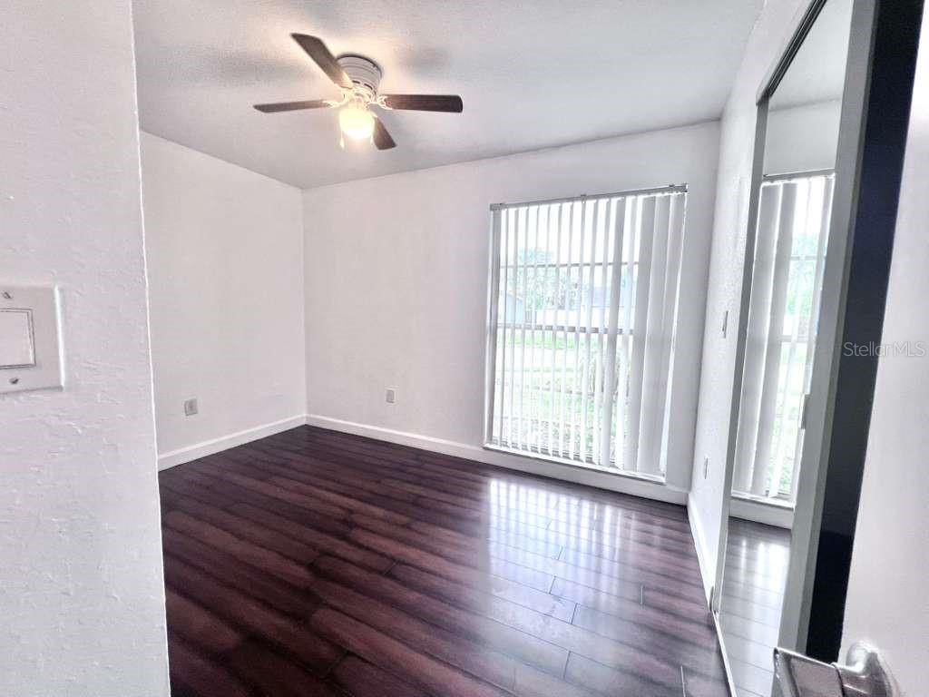 3409 Vorden Street New Port Richey, FL 34655 - Photo 19 of 41 a view of an empty room with wooden floor and a window