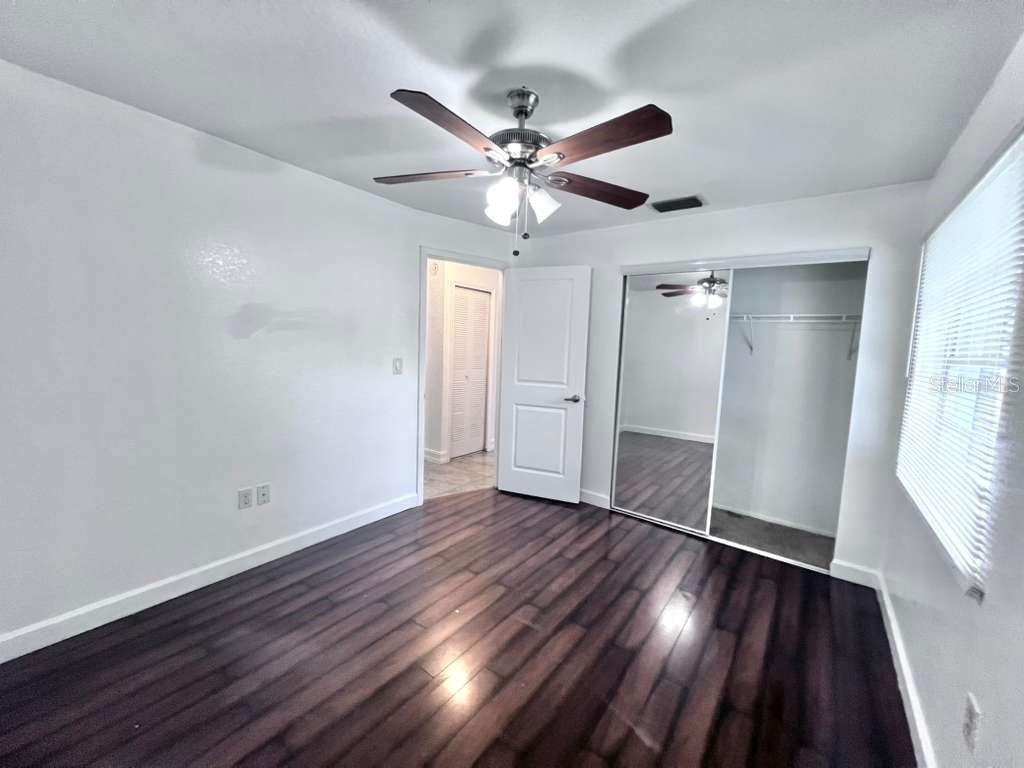 3409 Vorden Street New Port Richey, FL 34655 - Photo 20 of 41 a view of an empty room with wooden floor and a window