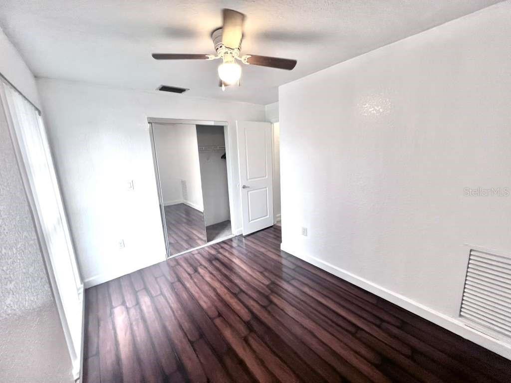 3409 Vorden Street New Port Richey, FL 34655 - Photo 22 of 41 wooden floor in an empty room with a window