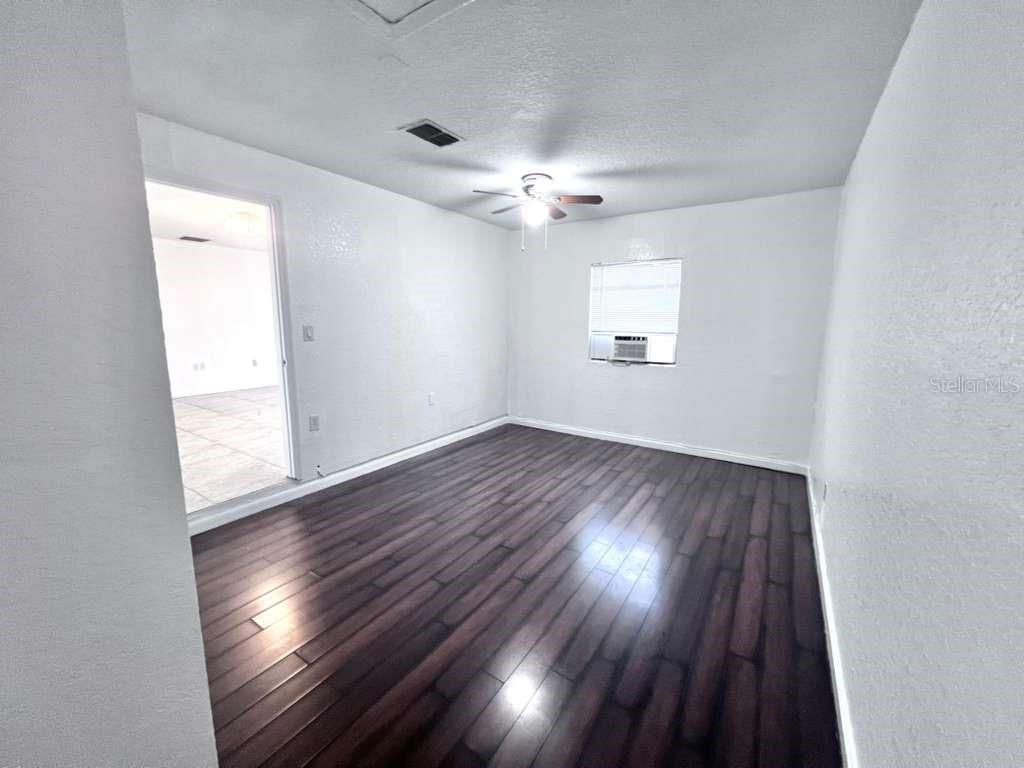 3409 Vorden Street New Port Richey, FL 34655 - Photo 23 of 41 an empty room with wooden floor and windows