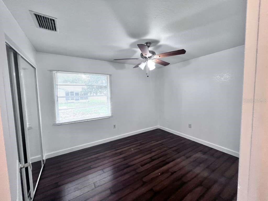 3409 Vorden Street New Port Richey, FL 34655 - Photo 27 of 41 wooden floor in an empty room with a window