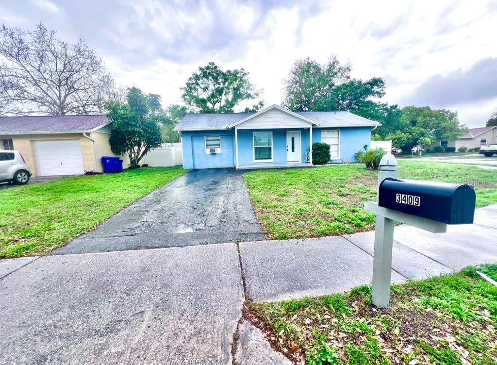 3409 Vorden Street New Port Richey, FL 34655 - Photo 5 of 41 a front view of a house with a yard and garage