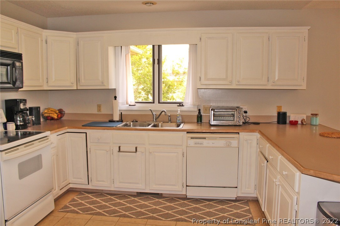 679 Cedar Point Vass, NC 28394 - Photo 4 of 18 a kitchen with a white cabinets sink and window