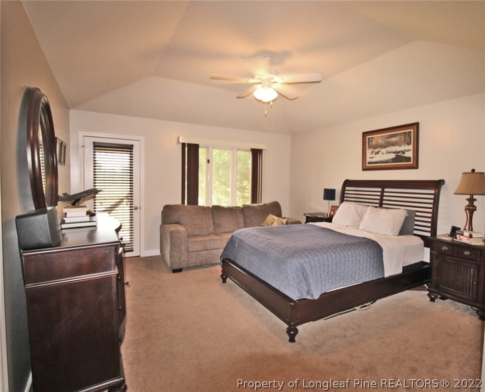 679 Cedar Point Vass, NC 28394 - Photo 7 of 18 a bedroom with a bed and a chandelier