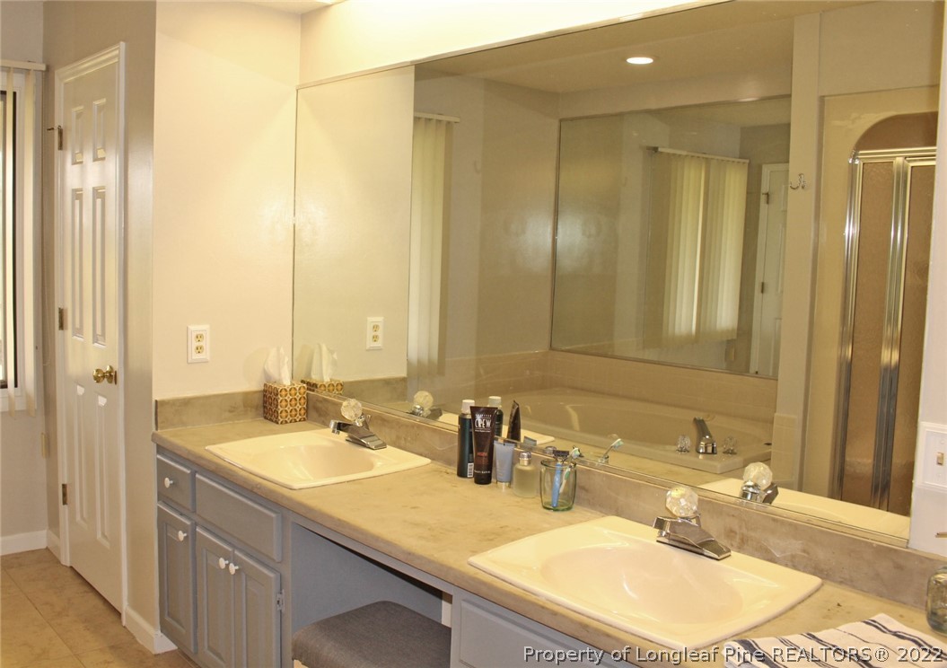 679 Cedar Point Vass, NC 28394 - Photo 8 of 18 a bathroom with a sink double vanity and a mirror