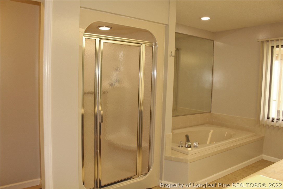 679 Cedar Point Vass, NC 28394 - Photo 9 of 18 a bathroom with a bathtub and a shower