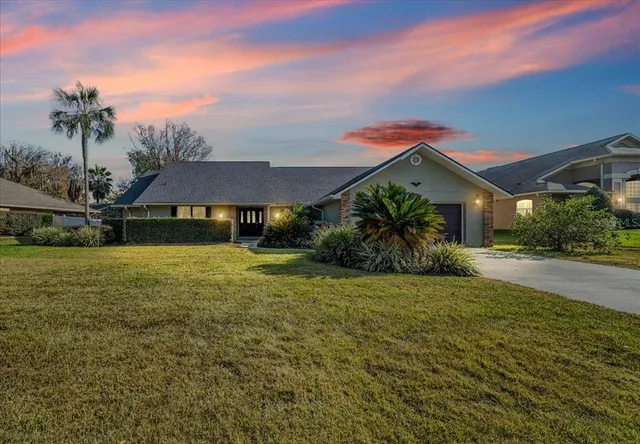 a front view of house with yard and green space